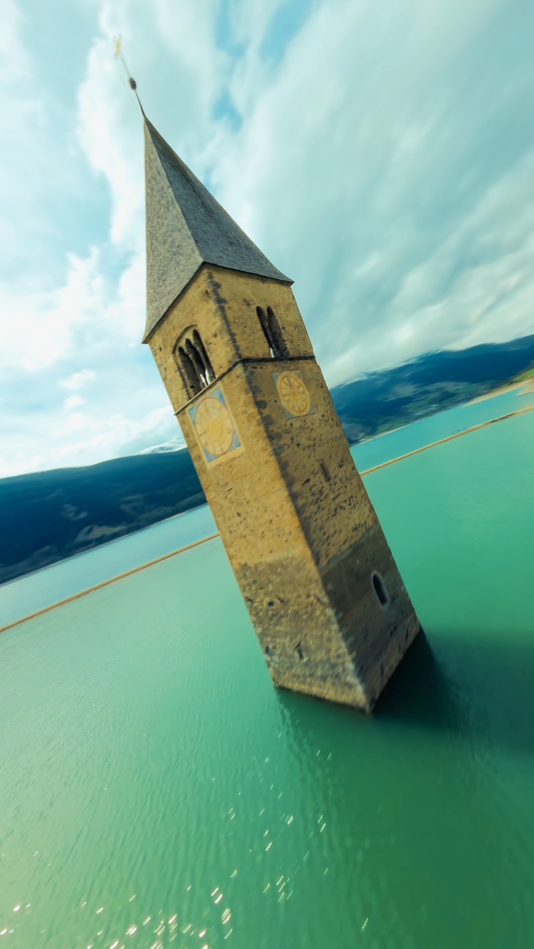 An aerial view of a church in a lake